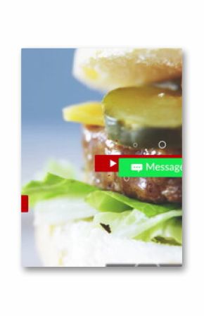 Showing stacked burger with pickles, tomato, cheese in studio with UI overlays, copy space