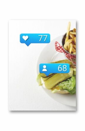 Displaying open-faced burger and fries on white table, with social icons, copy space