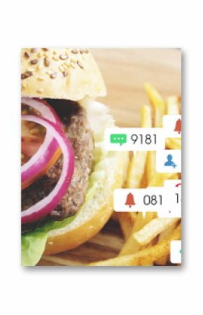Showing sesame burger and fries on wooden board over rustic cafe table, with social icons overlay