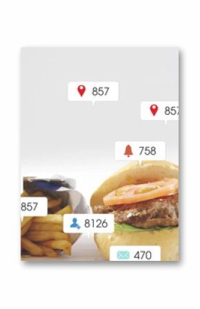 Displaying cheeseburger with lettuce and tomato by fries and cola on table, with notification icons