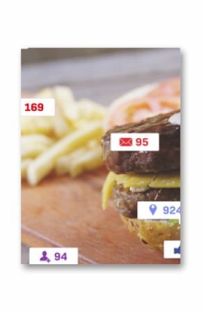 Showcasing double cheeseburger sitting on wooden board at dining area, with fries, engagement icons