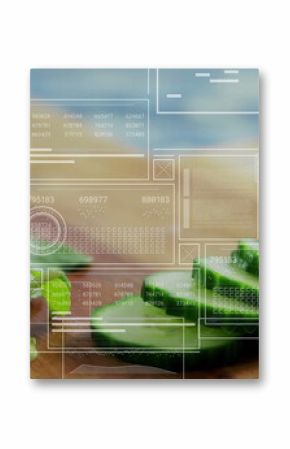 Showing sliced cucumber and watercress on wood cutting board on counter, with digital data overlays