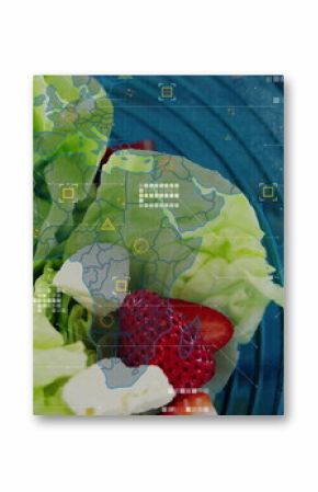 Presenting glass bowl of lettuce, halved strawberries and cheese cubes on wood table, data overlay