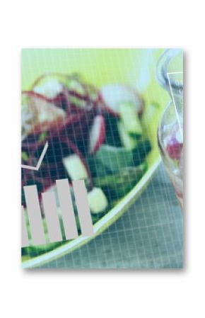 Displaying salad bowl with greens and cheese near infused water jar, under overlay charts and code