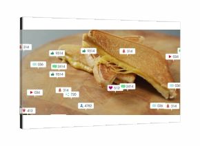 Showing grilled cheese sandwich halves stacking on cutting board with floating social media icons