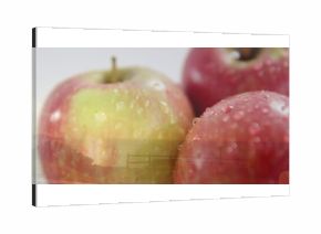 Glistening cluster of three apples gleaming on soft studio tabletop, texture highlight