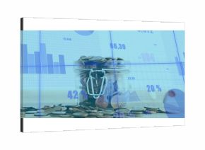 Glass jar holding coins on wooden office desk, featuring bar graphs pie charts percentages overlays