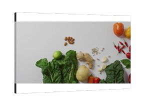 Displaying Swiss chard, ginger and almonds in flatlay on white countertop, showing colorful produce