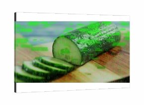 Displaying half cucumber resting on board at kitchen counter, with slices and binary code overlay