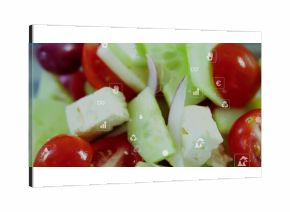 Displaying salad on counter with cucumber, tomatoes, red onion and cheese cubes with floating icons