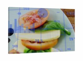 Stacked caprese salad resting on white plate at dining table, with blue data visualization overlay