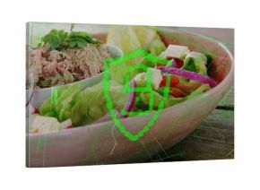 Displaying pastel-pink bowl holding salad on wooden table with white bowl of tuna, green overlay