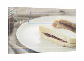 Displaying sandwich halves on white ceramic plate at tabletop, with jam jar and blue AR overlays