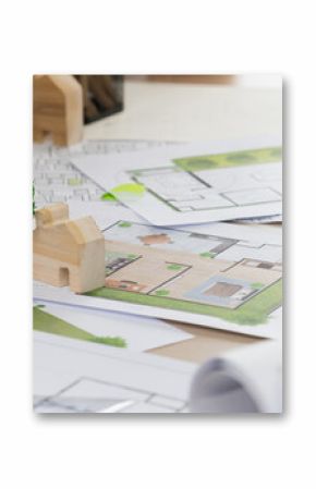 Sustainable eco house blueprint was placed on meeting table with architectural paper work scatter around during skilled architect discussion about green design of green city. Closeup. Delineation.