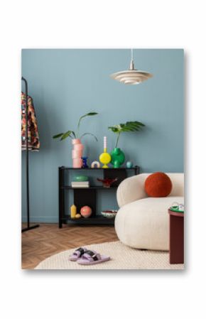 Modern and colorful interior of living room with design boucle sofa, mock up poster, shelf, plants, decorations and personal stuff. Home decor.