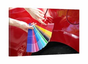 Female hands with paint samples choosing color for painting car, closeup