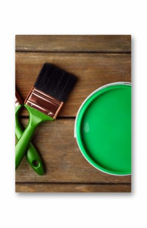 Paint can and paint brushes on wooden background