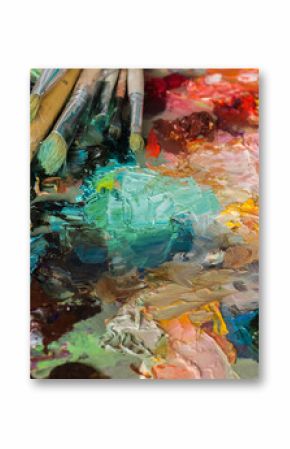 artist's palette with oil paints and brushes used for painting a