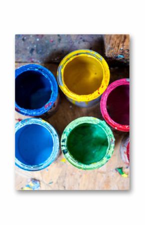 Colourful paint cans on the floor viewed from above