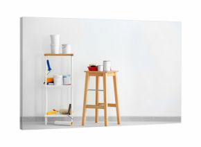 Composition with paint and decorator's tools near white wall