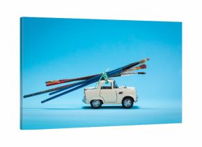 Car toy carrying paint brushes