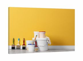 Set with decorator tools and paint on floor near color wall