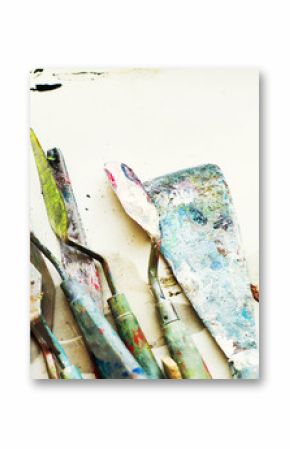 Various palette knives in oil paint after use on the table. Artist Tools