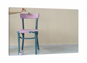  woman's hand painting chair in pink at home