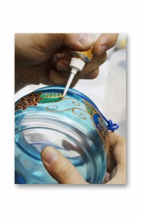 painting with  stained glass paints and line paints on transparent blue glass jar