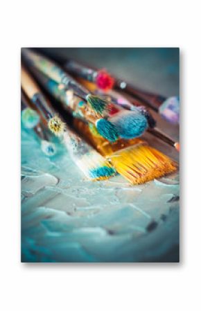 Paintbrushes on artist canvas covered with oil paints. Retro sty