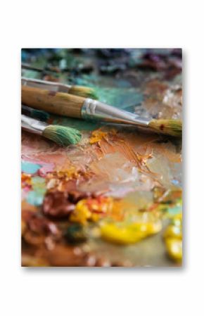 artists brushes and oil paints on wooden palette