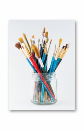 Artist paint brushes in a glass jar