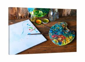 Palettes, brushes and canvas in an old painting workshop