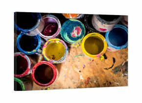 Colourful paint cans on the floor viewed from above