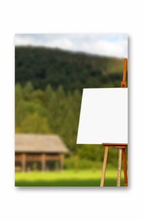 Blank painter artist canvas on easel with mountain in background