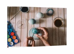 Person painting the eggs