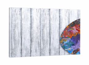 Palette for oil paints with brushes and autumn leaves