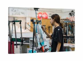 Creative woman painting in studio