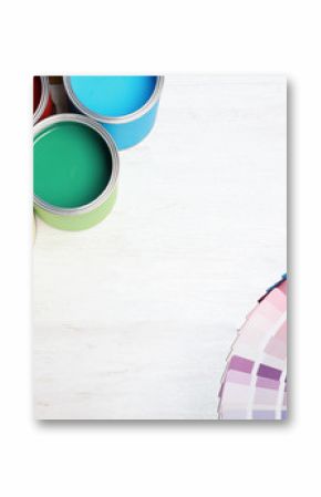 Flat lay composition with paint cans and color palette on wooden background. Space for text