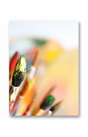 Different paint brushes on blurred background, closeup. Space for text