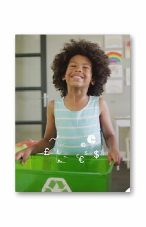 Standing child showcasing green recycling bin in school classroom, with climate awareness posters