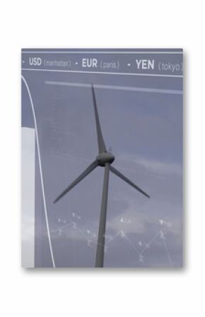 Displaying modern wind turbine standing against cloudy sky at wind farm, with financial overlays