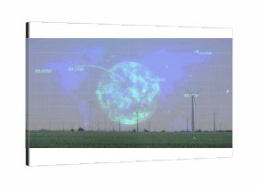 Displaying holographic globe showing numeric data flows over grass field with wind turbines, towers
