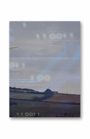 Towering wind turbine standing on ridge on farmland with hedgerows and circuit overlay, copy space