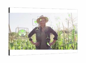 Standing woman in straw hat and jacket among corn stalks late afternoon, with floating energy icons
