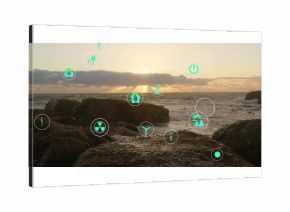 Floating circular badges displaying green energy icons over volcanic rocks by sea at sunset