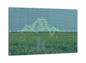 Overlaying digital line graph on open farmland, with wind turbines and numeric data