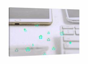 Displaying white tablet sitting on desk, showing eco icons over smartphone, keyboard, copy space