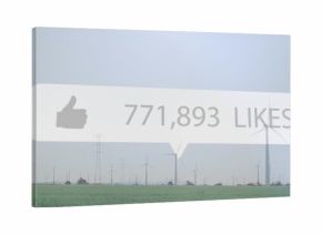 Floating speech-bubble hovering crop field, showing thumbs-up 771,893 likes, turbines