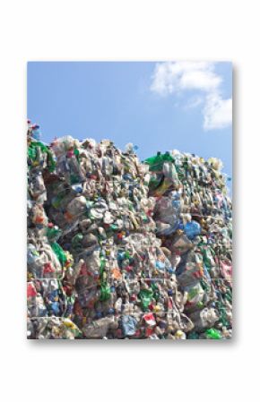 Stack of plastic bottles for recycling against blue sky